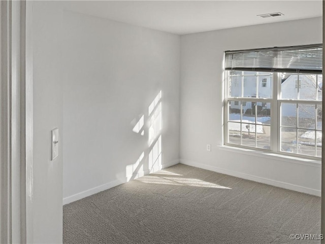 carpeted empty room featuring a healthy amount of sunlight