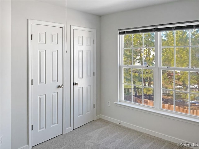 unfurnished bedroom with light carpet