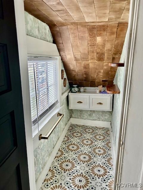 bathroom with lofted ceiling, wooden ceiling, and tile patterned flooring