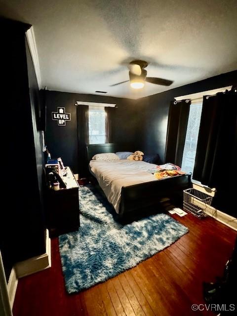 bedroom featuring dark wood-type flooring and ceiling fan