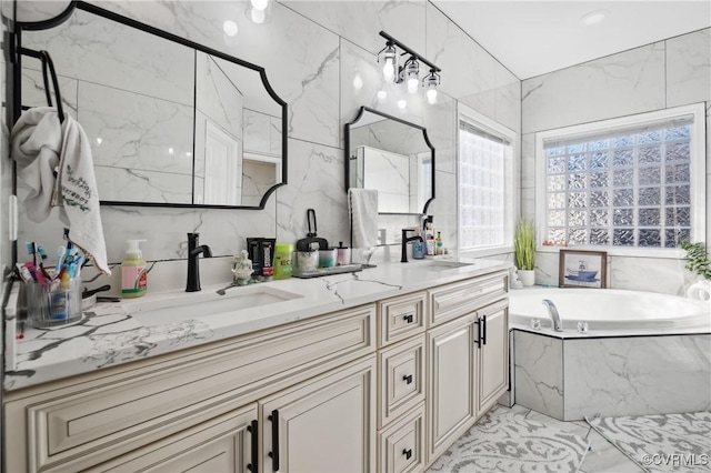 bathroom featuring vanity and tiled tub