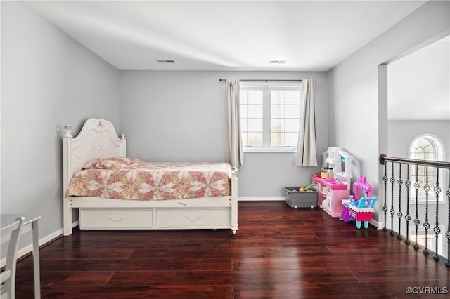 bedroom with dark wood-type flooring