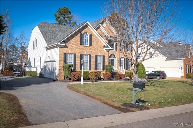 view of front of property featuring a front yard and a garage