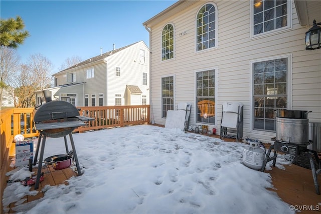 snow covered property featuring a deck