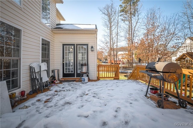 snow covered deck featuring grilling area