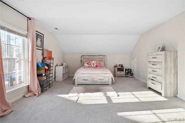 bedroom featuring vaulted ceiling and light carpet