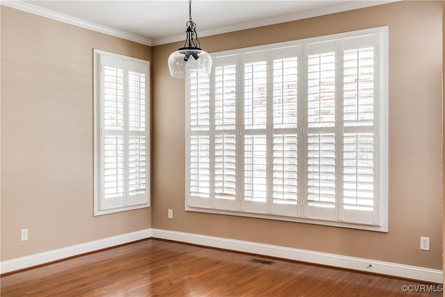 unfurnished room with ornamental molding and hardwood / wood-style flooring