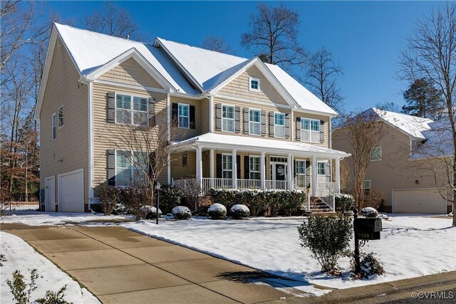 view of front of home featuring covered porch and a garage