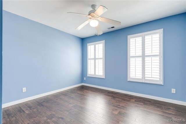 spare room with ceiling fan and dark hardwood / wood-style floors