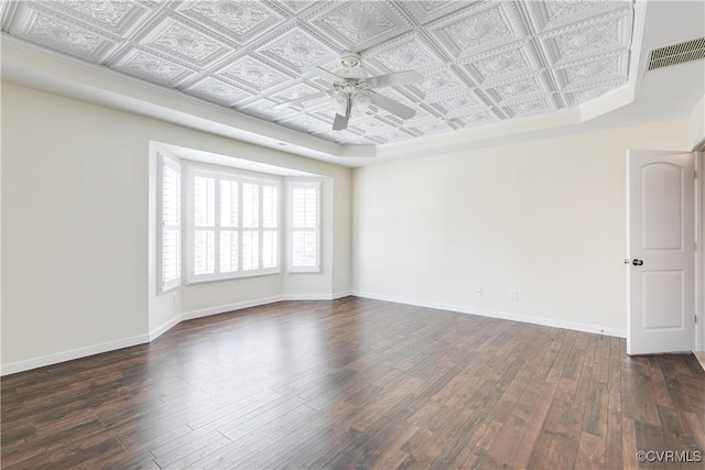 empty room with ceiling fan and dark hardwood / wood-style floors