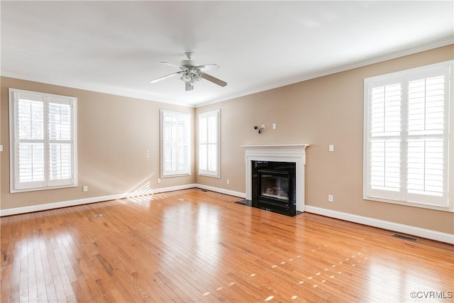 unfurnished living room featuring ceiling fan, light hardwood / wood-style flooring, and crown molding