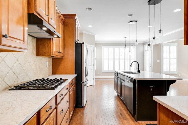 kitchen with appliances with stainless steel finishes, backsplash, decorative light fixtures, ornamental molding, and sink