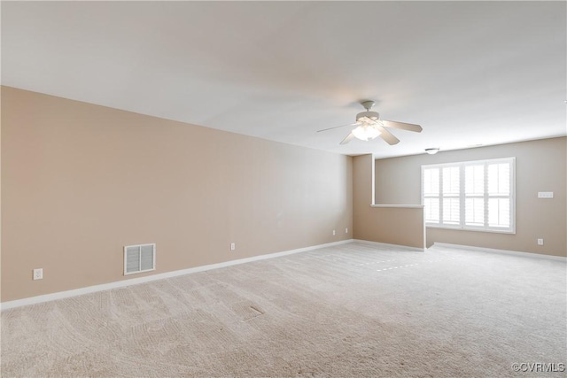 carpeted spare room featuring ceiling fan