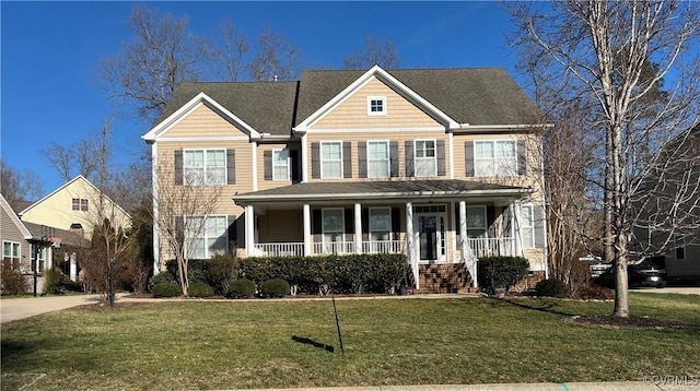 view of front of home featuring covered porch and a front lawn