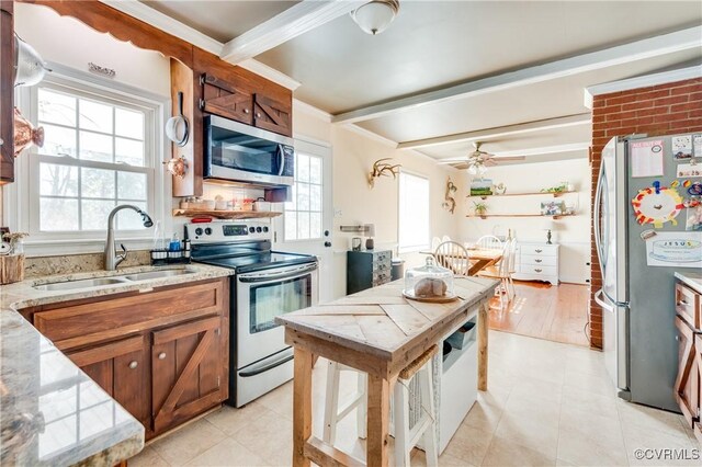 kitchen with sink, appliances with stainless steel finishes, ceiling fan, crown molding, and beam ceiling