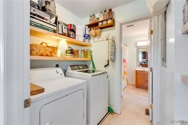 washroom with washer and dryer and light tile patterned flooring