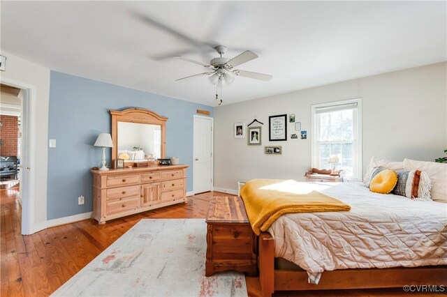 bedroom with ceiling fan and light hardwood / wood-style floors