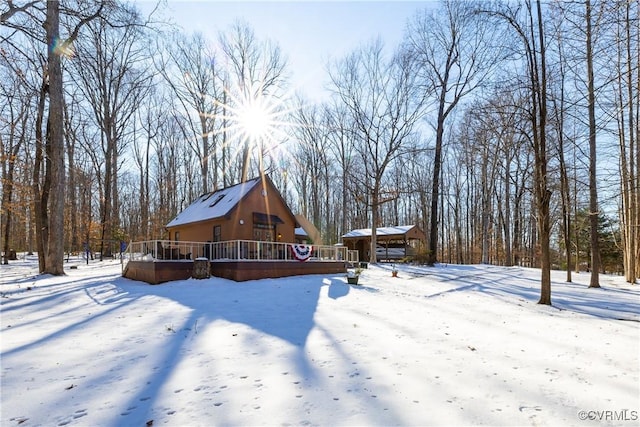 yard covered in snow with a wooden deck