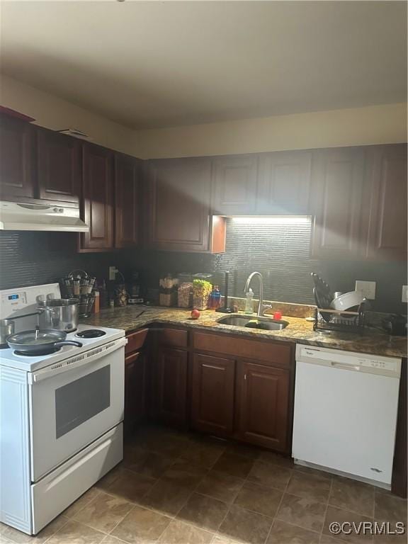 kitchen featuring sink, white appliances, stone counters, and dark brown cabinets