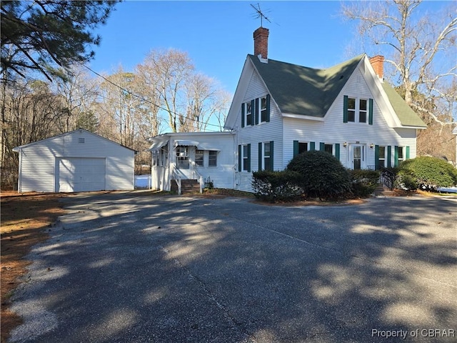 view of home's exterior with a garage and an outdoor structure