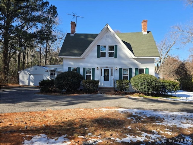 view of front of property featuring a garage and an outdoor structure