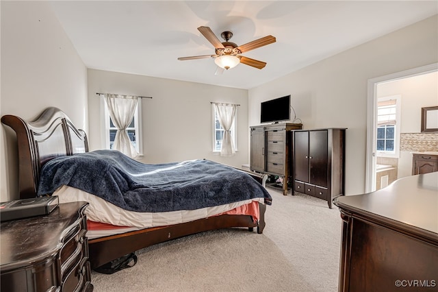 carpeted bedroom with ceiling fan and multiple windows