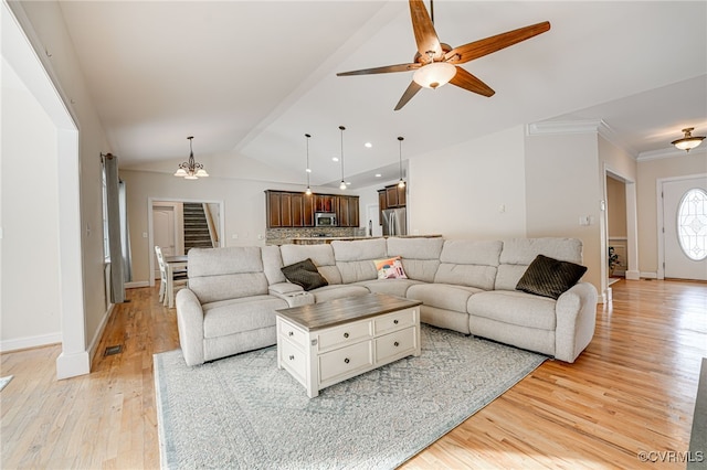 living room with light hardwood / wood-style flooring, vaulted ceiling, crown molding, and ceiling fan with notable chandelier