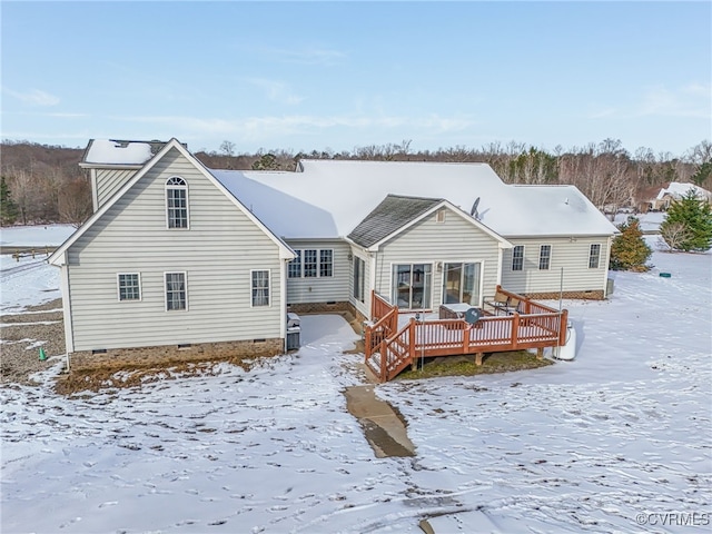 snow covered property with a deck