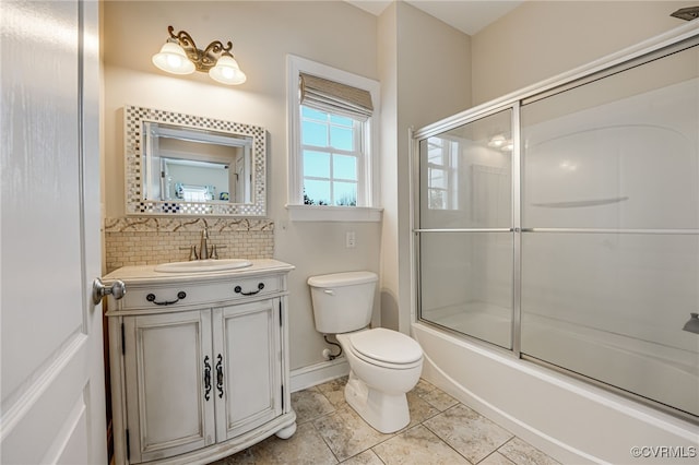 full bathroom with tasteful backsplash, toilet, tile patterned floors, bath / shower combo with glass door, and vanity