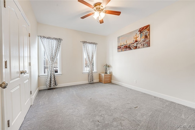 unfurnished room featuring ceiling fan and light carpet