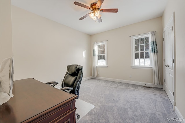 carpeted home office with ceiling fan