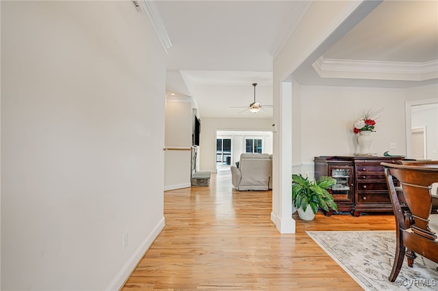 corridor featuring french doors, light wood-type flooring, and crown molding