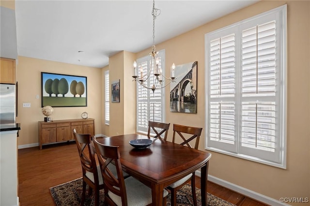 dining space with a chandelier and dark hardwood / wood-style floors