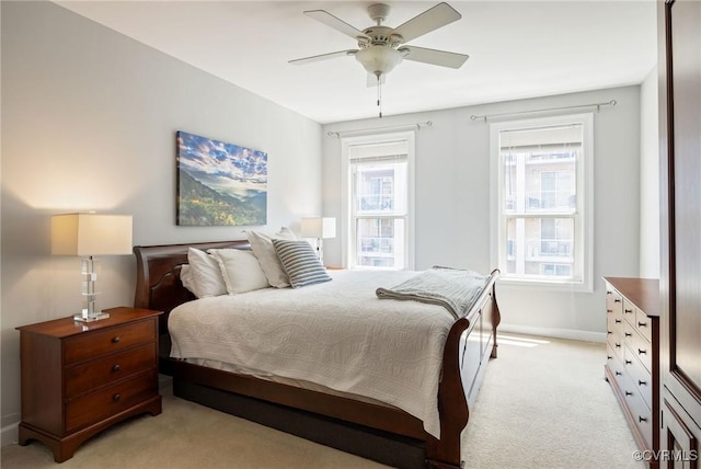 bedroom with ceiling fan and light colored carpet