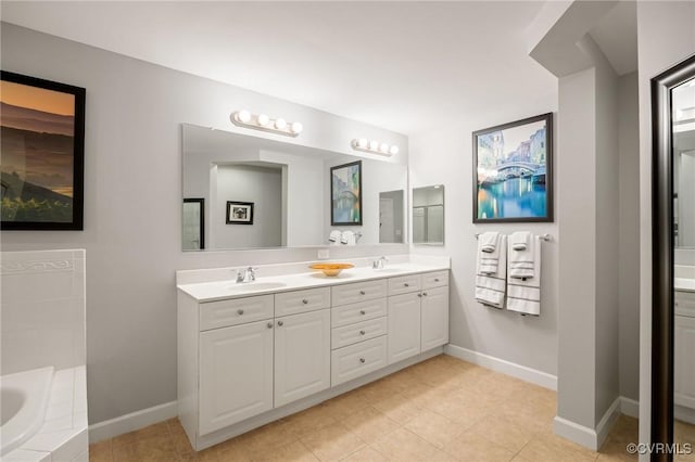 bathroom with vanity, tile patterned flooring, and a relaxing tiled tub