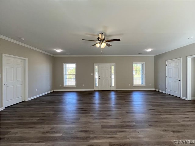 empty room featuring ornamental molding, ceiling fan, a healthy amount of sunlight, and dark hardwood / wood-style floors