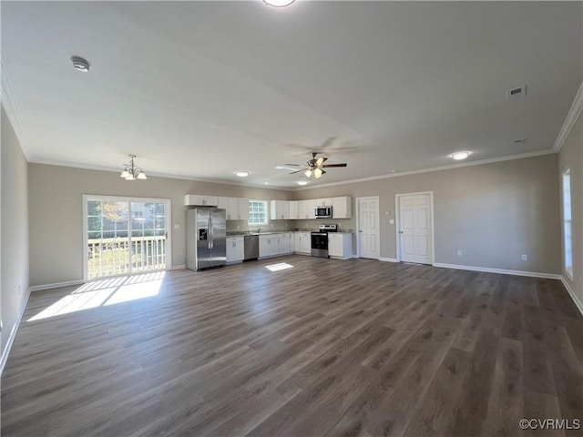 unfurnished living room featuring ceiling fan with notable chandelier, dark hardwood / wood-style flooring, and crown molding