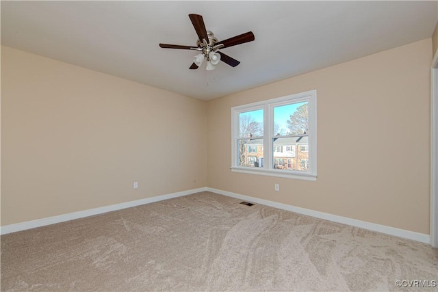 unfurnished room with light colored carpet and ceiling fan