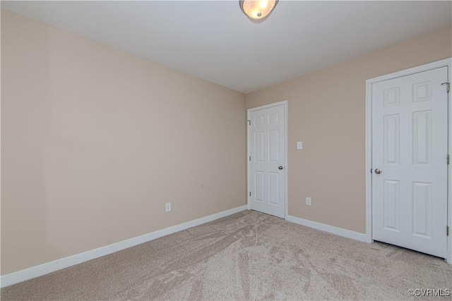 unfurnished bedroom with light colored carpet