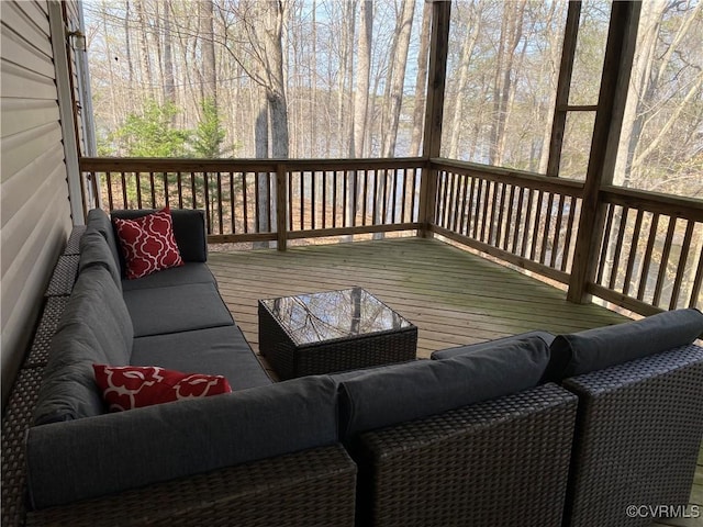 wooden terrace with an outdoor living space