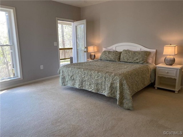 carpeted bedroom with access to exterior and multiple windows