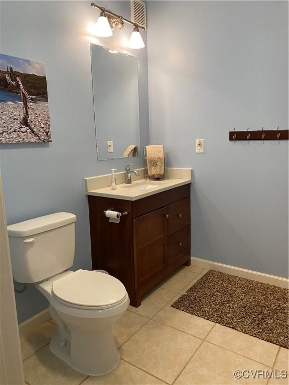 bathroom featuring toilet, vanity, and tile patterned floors