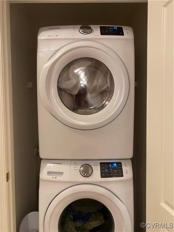 laundry area featuring stacked washer / drying machine