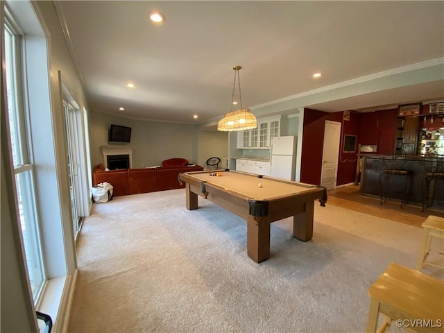 recreation room with billiards, ornamental molding, and a healthy amount of sunlight