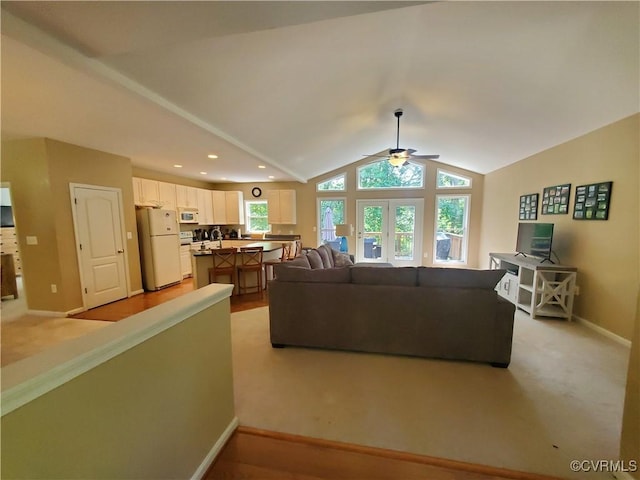 living room with vaulted ceiling, ceiling fan, a healthy amount of sunlight, and french doors