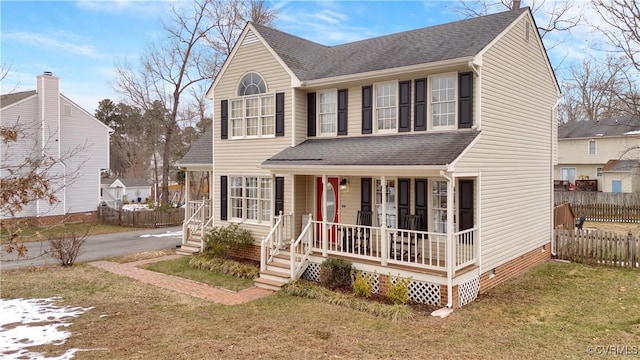 view of front of home featuring a front yard and a porch