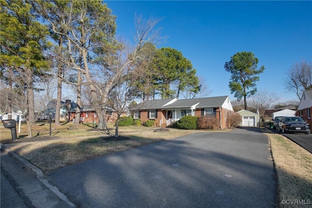 ranch-style home with an outbuilding and a garage