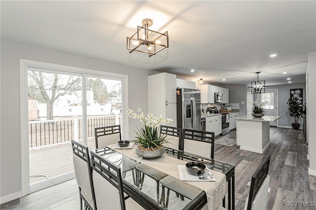 dining room with plenty of natural light, a chandelier, and hardwood / wood-style flooring