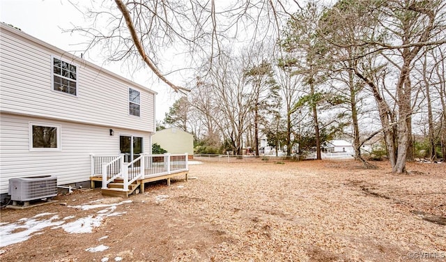 view of yard featuring cooling unit and a deck