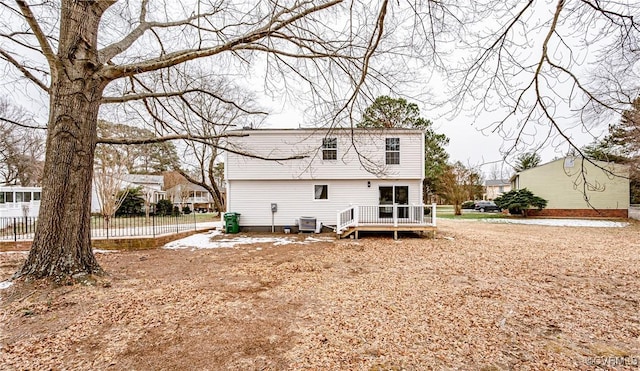 back of property featuring central AC unit and a wooden deck